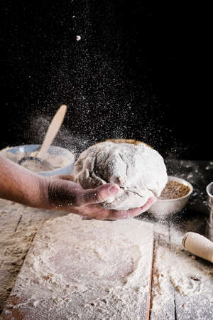 Beat flour and kitchen utensils, a baking dish, a rolling pin with eggs on the table. Baking,...