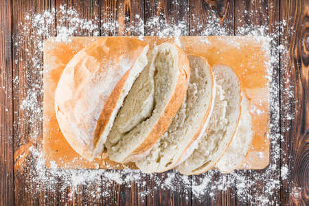 Different baking buns, croissants, gingerbread cookies. Delicious freshly baked bread on wooden...