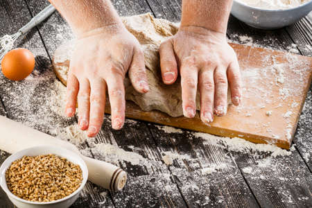 Beat flour and kitchen utensils, a baking dish, a rolling pin with eggs on the table. Baking,...