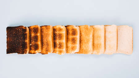 slices of bread fried in a toaster from burnt to freshの写真素材