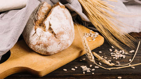 Different baking buns, croissants, gingerbread cookies. Delicious freshly baked bread on wooden background with place for text. Fresh loaves of bread And sliced ââbreads containing sesame seeds.の写真素材