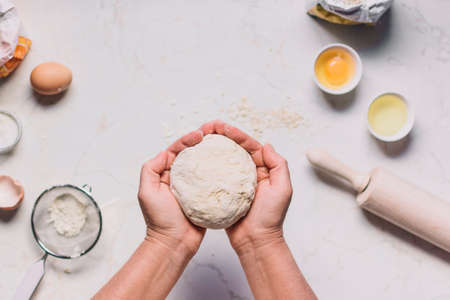Beat flour and kitchen utensils, a baking dish, a rolling pin with eggs on the table. Baking,...