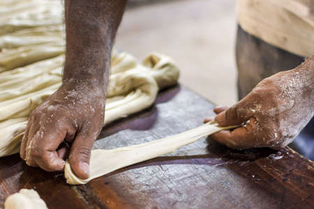 Beat flour and kitchen utensils, a baking dish, a rolling pin with eggs on the table. Baking,...
