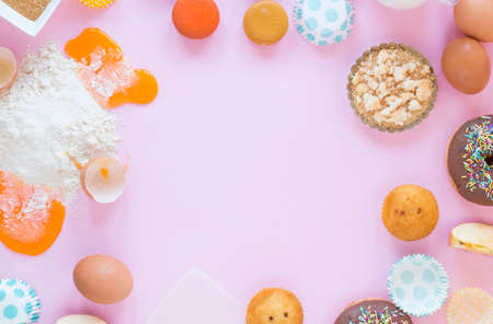 Flour and kitchen utensils whisk, baking dish, rolling pin with eggs on the table. Baking, cooking concept, top view with place for text.の写真素材
