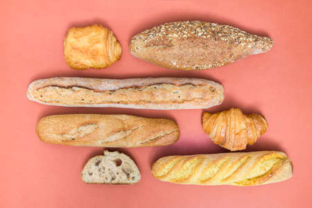 Different baking buns, croissants, gingerbread cookies. Delicious freshly baked bread on wooden...