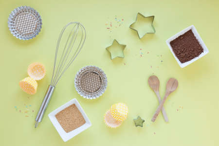 Flour and kitchen utensils whisk, baking dish, rolling pin with eggs on the table. Baking, cooking...