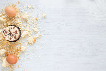 Flour and kitchen utensils whisk, baking dish, rolling pin with eggs on the table. Baking, cooking...