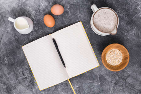 Different baking buns, croissants, gingerbread cookies. Delicious freshly baked bread on wooden background with place for text. Fresh loaves of bread And sliced ââbreads containing sesame seeds.の写真素材