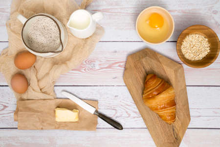 Flour and kitchen utensils whisk, baking dish, rolling pin with eggs on the table. Baking, cooking...