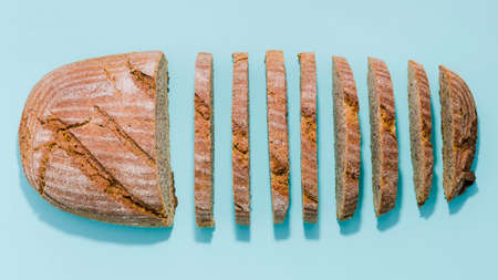 Different baking buns, croissants, gingerbread cookies. Delicious freshly baked bread on wooden background with place for text. Fresh loaves of bread And sliced ââbreads containing sesame seeds.の写真素材