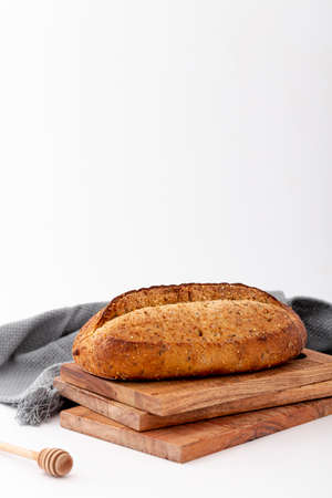 Different baking buns, croissants, gingerbread cookies. Delicious freshly baked bread on wooden background with place for text. Fresh loaves of bread And sliced ââbreads containing sesame seeds.の写真素材