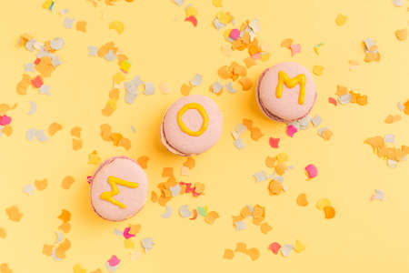 Topper with words HAPPY MOTHER'S DAY or valentine day in cupcake on color background and flower
