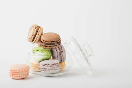 Colorful macarons pattern background. Bakery sweets concept background. Cake macaron or macaroon on turquoise background from above, colorful almond cookies, pastel colors, vintage card.の写真素材