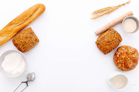 Different baking buns, croissants, gingerbread cookies. Delicious freshly baked bread on wooden...