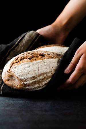 Different baking buns, croissants, gingerbread cookies. Delicious freshly baked bread on wooden...