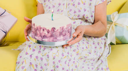 Woman hand holding cake or pieの写真素材