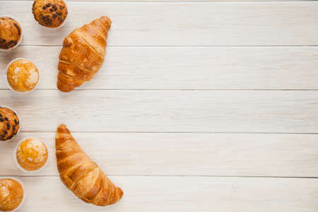 Healthy breakfast - muesli with blueberry and honey, yogurt, growing, juice. Top view. Bakery cupcake with jam and coffee.の写真素材