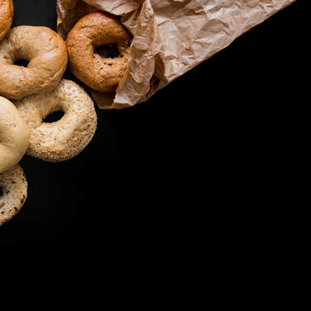Donuts. donuts in hand. Donuts are fried, glazed, and put on racks in a donut shop bakery. Fried Donuts with Powdered sugar icing.の写真素材