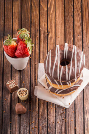 Beautiful donuts with chocolate glaze filling. Bakery sweets concept background.の写真素材