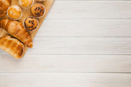 Healthy breakfast - muesli with blueberry and honey, yogurt, growing, juice. Top view. Bakery cupcake with jam and coffee.の写真素材