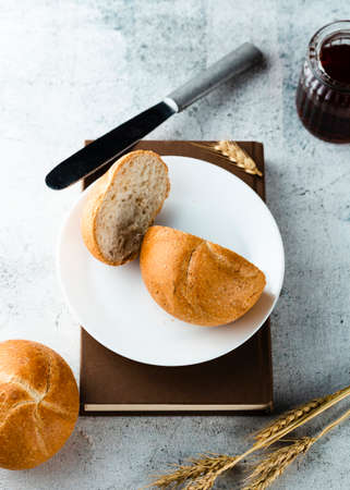 Different baking buns, croissants, gingerbread cookies. Delicious freshly baked bread on wooden background with place for text. Fresh loaves of bread And sliced ââbreads containing sesame seeds.の写真素材