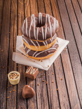 Beautiful donuts with chocolate glaze filling. Bakery sweets concept background.