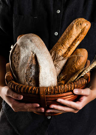 Different baking buns, croissants, gingerbread cookies. Delicious freshly baked bread on wooden...