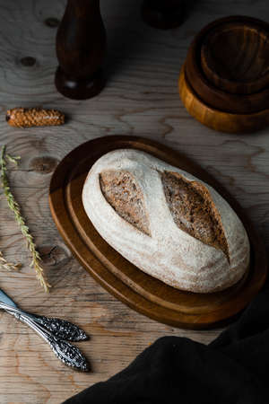 Different baking buns, croissants, gingerbread cookies. Delicious freshly baked bread on wooden background with place for text. Fresh loaves of bread And sliced ââbreads containing sesame seeds.の写真素材
