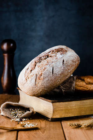 Different baking buns, croissants, gingerbread cookies. Delicious freshly baked bread on wooden...