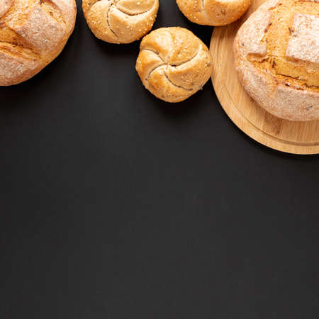 Different baking buns, croissants, gingerbread cookies. Delicious freshly baked bread on wooden...
