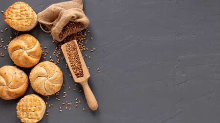 Different baking buns, croissants, gingerbread cookies. Delicious freshly baked bread on wooden...