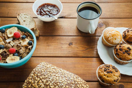 Healthy breakfast - muesli with blueberry and honey, growing, and coffee. Selective focus. Top view....
