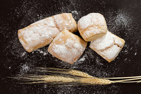 Different baking buns, croissants, gingerbread cookies. Delicious freshly baked bread on wooden...