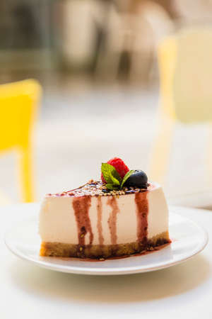 Piece of raspberries cake on plate isolated.の写真素材