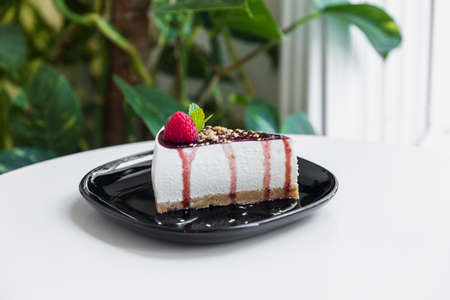 Piece of raspberries cake on plate isolated.