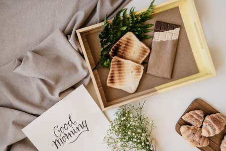 Croissant and cup of coffee on a wooden table with place for text.の写真素材