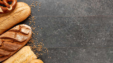 Different baking buns, croissants, gingerbread cookies. Delicious freshly baked bread on wooden...