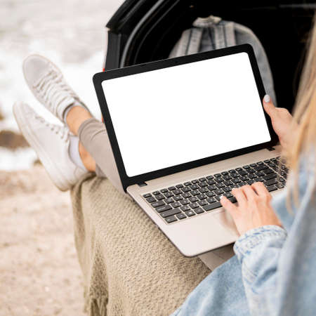 A person standing in front of a laptop. High quality photoの写真素材