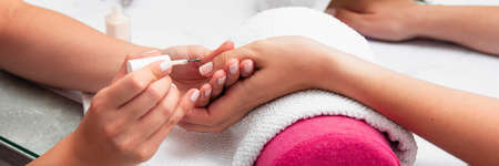 A close up of a persons hand. woman doing her manicure salon. High quality photoの写真素材