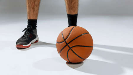 Young man s feet playing basketball. High quality photoの写真素材