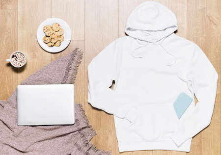 A person with collar shirt. white hoodie with cookies plate laptop. High quality photoの写真素材