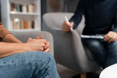 woman holding hands together talking with counselor. High quality photoの写真素材