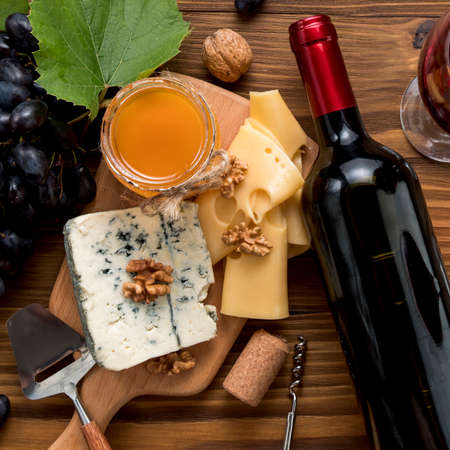 A close up of items on a table. wine with food wooden background. High quality photoの写真素材