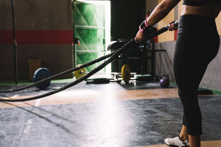 A person holding a baseball bat. Woman with rope. High quality photoの写真素材