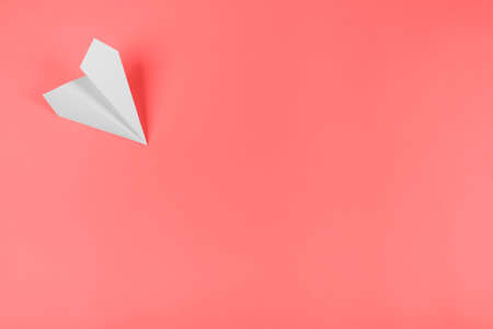 Background pattern. white paper airplane corner coral backgroundの写真素材