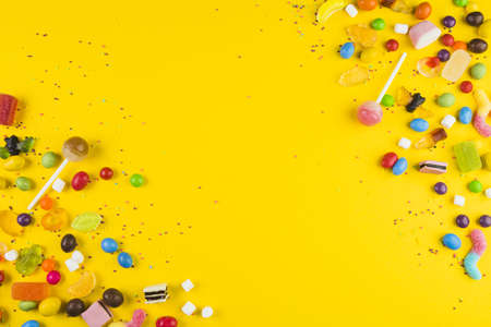 various colorful candies lollipops yellow surface. Resolution and high quality beautiful photoの写真素材