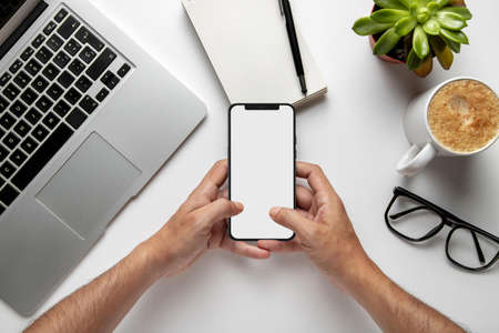 top view man using smartphone with laptop coffee. Resolution and high quality beautiful photo