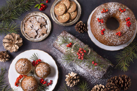 top view of christmas desserts with red berries and pine cones. Resolution and high quality beautiful photoの写真素材