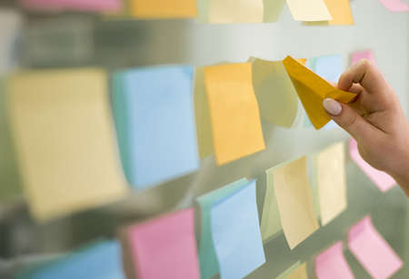 side view hand putting sticky notes window. Resolution and high quality beautiful photo