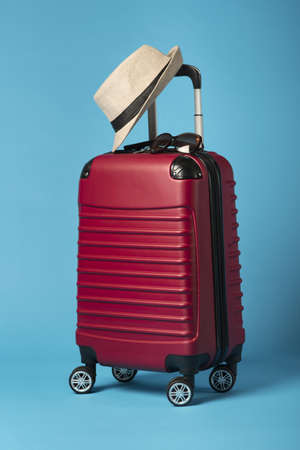 red luggage with blue background. Resolution and high quality beautiful photoの写真素材